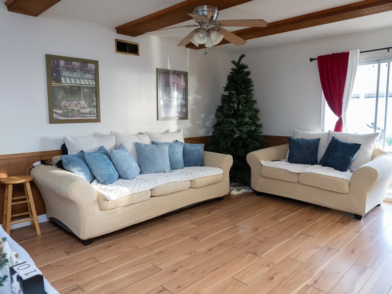 Comfortable common living area with cozy seating arrangements and natural lighting for resident gatherings.